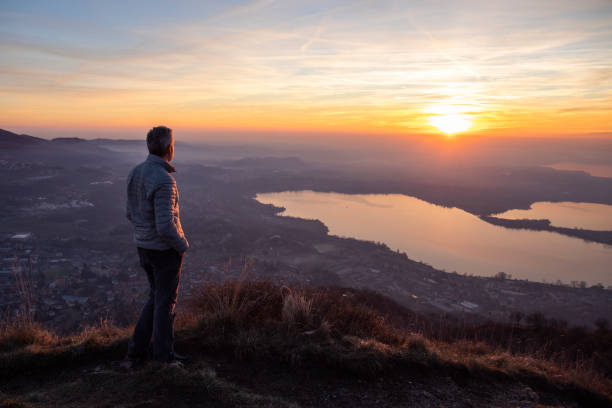 Hiker looking at sun over horizon, symbolizing reaching potential